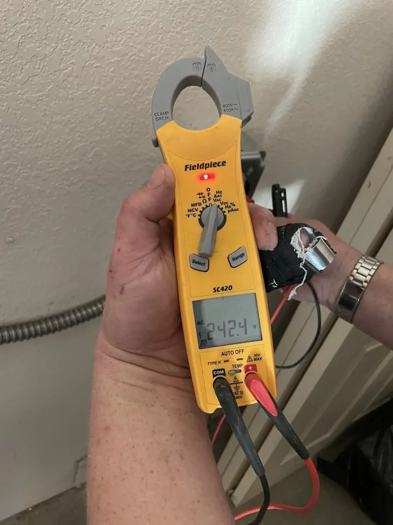 Voltage testing with clamp meter during Recessed Lighting Installation in Minoa